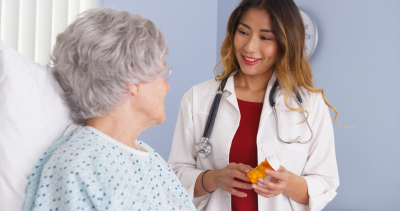 nurse giving her patient a medicine