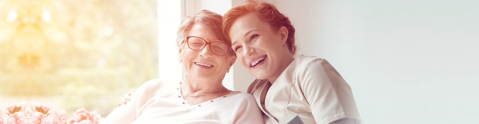 smiling elderly woman with smiling middle aged woman outdoor